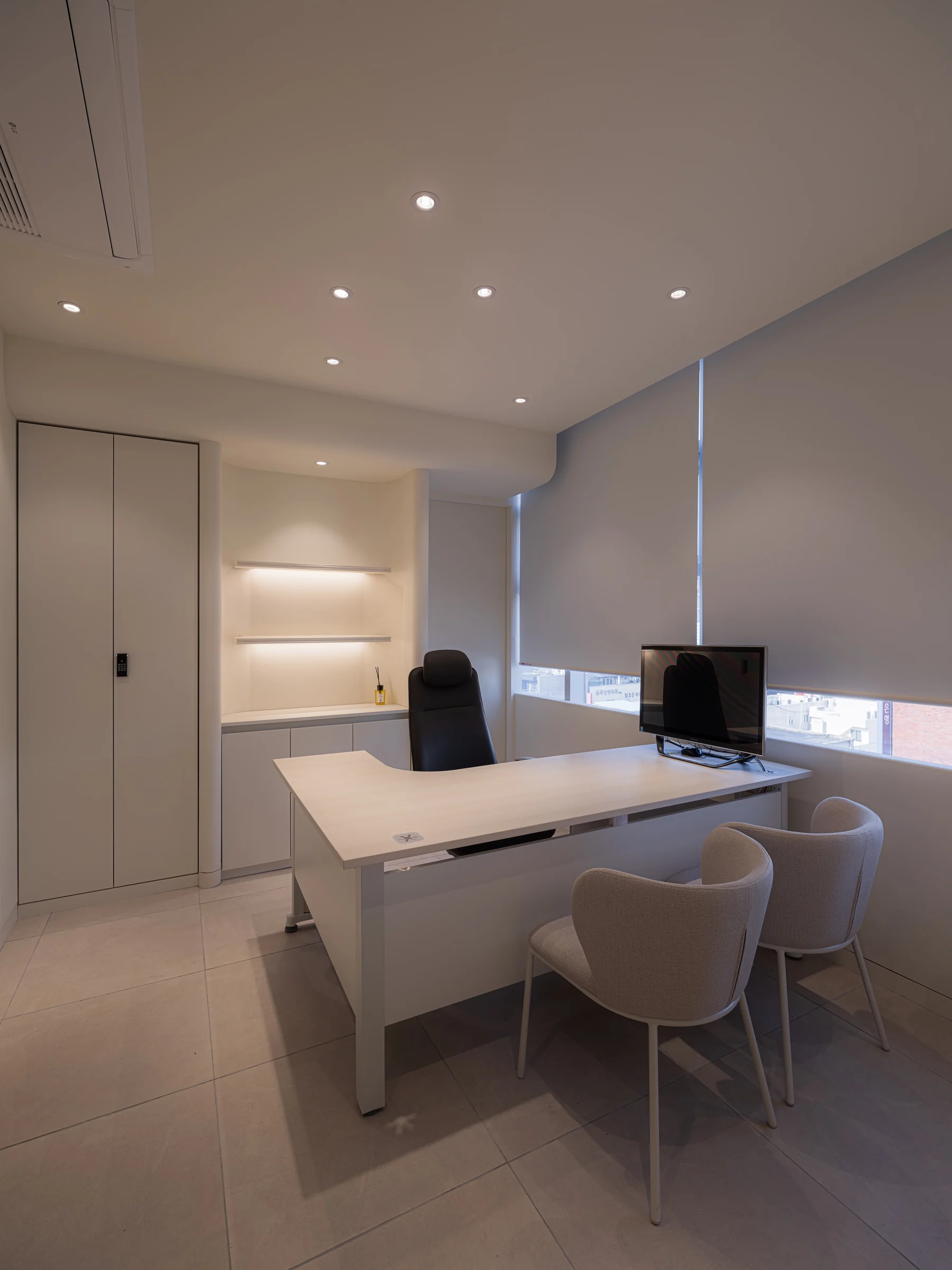 The doctor consultation room with a desk, chairs, and a monitor for reviewing your eye analysis