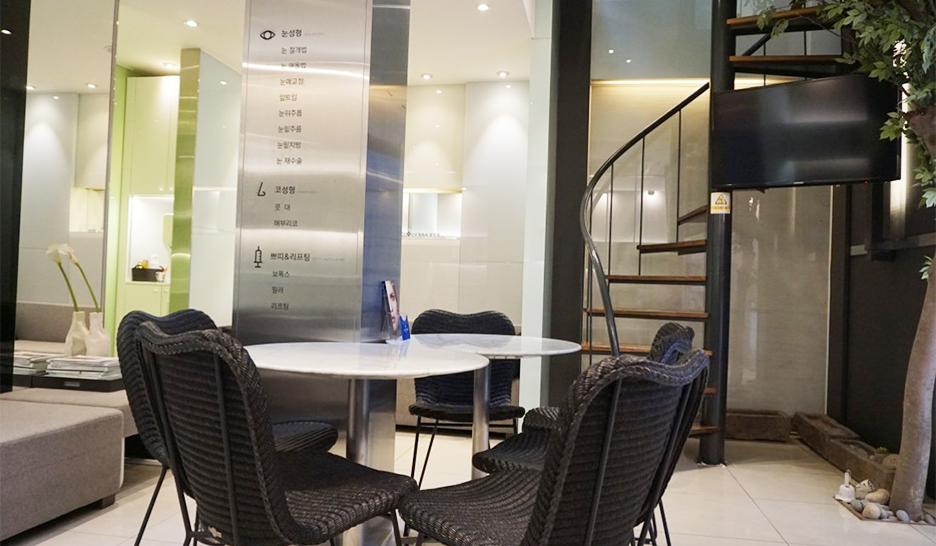 Waiting area with a glass partition, tables, and chairs